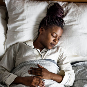 Woman sleeping soundly in the comfort of her own home after a general surgery procedure.